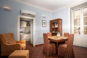 ein Esszimmer mit einem Tisch und Stühlen in der Unterkunft I Tre Balconi di Via Roma Apartment in Syrakus