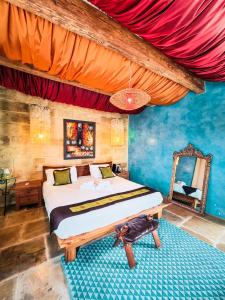 a bedroom with a bed and a cat standing on a rug at Chapel 5 Boutique Suites B&B in Naxxar