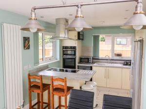 a kitchen with a table and chairs and appliances at Meadowbank Lodge in Brandesburton