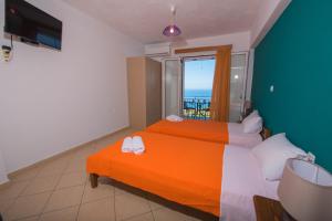 a bedroom with two beds and a view of the ocean at Elena Studios in Athani