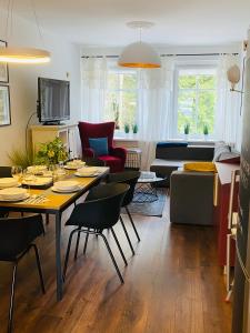 a living room with a table and chairs at Apartament Zdrój Lądek in Lądek-Zdrój