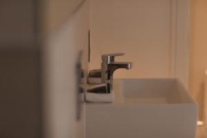 a bathroom with a sink and a faucet at The Loft, Bootham House - luxury city centre apartment with parking space in York