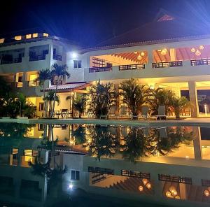 a large building with a swimming pool at night at Residencial Paraiso Bayahibe in Bayahibe