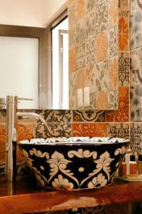 Kay Apartments Isla Mujeres في إيسلا موخيريس: حمام مع حوض كبير أسود و أبيض