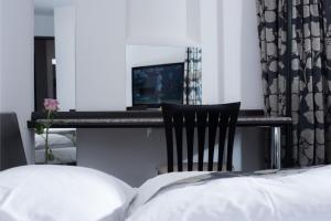 Letto o letti in una camera di Grand Hôtel Les Endroits