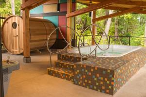 a jacuzzi tub in the middle of a house at Hotel Zed Tofino in Tofino