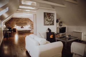 a living room with a white couch and a fireplace at Courtyard Cottages in Tralee