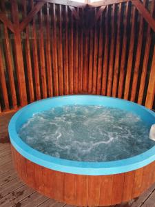 a large hot tub in a wooden deck with at Kovács Guesthouse in Praid