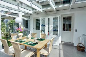 a dining room with a wooden table and chairs at Haus Tapken mit Meerblick in Varel