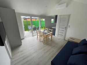 a living room with a table and a couch at Premium Home Rozewie in Władysławowo