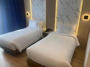 Un ou plusieurs lits dans un hébergement de l'établissement Rihab Hotel
