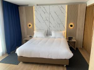Un ou plusieurs lits dans un hébergement de l'établissement Rihab Hotel
