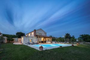 a house with a swimming pool in front of it at Villa Jerolim in Slivnica