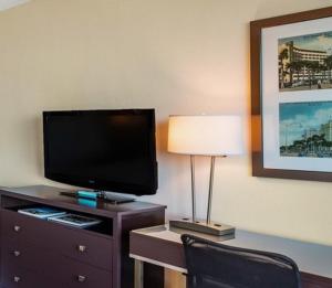 a hotel room with a television and a desk with a lamp at Holiday Inn Hotel Port of Miami-Downtown, an IHG Hotel in Miami