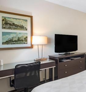 a hotel room with a desk with a television and a chair at Holiday Inn Hotel Port of Miami-Downtown, an IHG Hotel in Miami