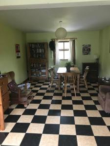 a living room with a table and a checkered floor at Teach an Ghleanna in Glengarriff