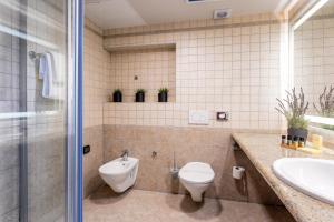 a bathroom with a toilet and a sink at Hotel Podstine in Hvar