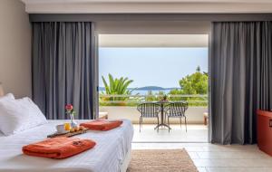 a bedroom with a bed and a balcony at Hotel Podstine in Hvar