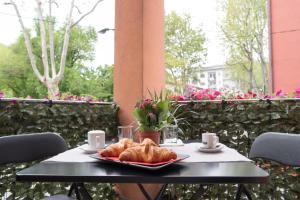 a table with a plate of croissants on it at Venice Rooms in Mestre