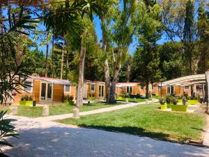 a row of houses in a park with trees at Baia Dei Micenei in Otranto