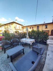 a patio with three benches and a table with at Appartamento "Da Mamma Agnese" in Gorgonzola
