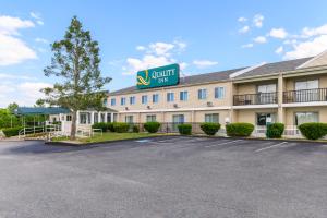 a front view of a hotel with a parking lot at Quality Inn in Bourne