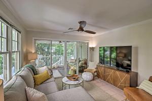 a living room with a couch and a tv at Charming Boho Breeze Retreat with Pool Access in Key West