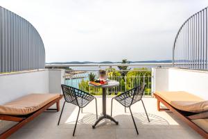 a patio with chairs and a table on a balcony at Hotel Podstine in Hvar