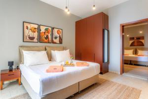 a bedroom with a large white bed with a mirror at Hotel Podstine in Hvar