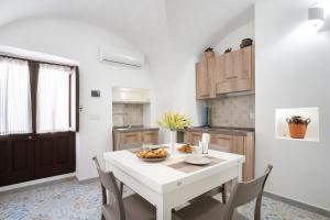 a kitchen with a white table and some chairs at La Finestrella in Parabita