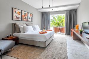 a bedroom with a bed and a large window at Hotel Podstine in Hvar