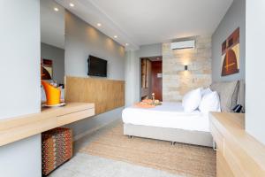 a bedroom with a bed and a tv on a wall at Hotel Podstine in Hvar