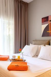 a bed with a tray of food on top of it at Hotel Podstine in Hvar