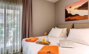 a hotel room with a bed with a laptop on it at Hotel Podstine in Hvar