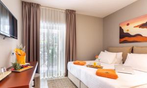 a hotel room with a bed and a desk at Hotel Podstine in Hvar