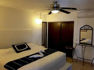 een slaapkamer met een bed en een plafondventilator bij Penthouse VLM Gran Terraza 200 metros vista inmejorable piscina gigante in Acapulco