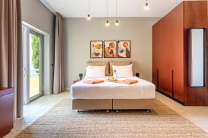 a bedroom with a large bed and a large window at Hotel Podstine in Hvar