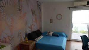 a bedroom with a blue bed and a flower wall at Marula Apartment in Račišće