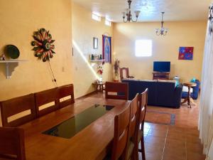 a living room with a table and a couch at Villa Las Campanas in San Juan Teotihuacán