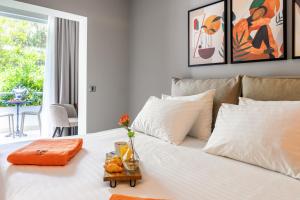a white bed with a tray of food on it at Hotel Podstine in Hvar