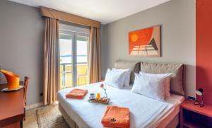 a hotel room with a bed with two towels on it at Hotel Podstine in Hvar
