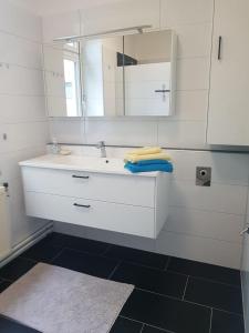 a bathroom with a white sink and a mirror at Ferienwohnung Gmünd in Gmünd