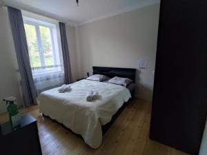 a bedroom with a bed with two towels on it at Kamara Guest House in Stepantsminda