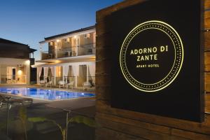 a sign for a boutique hotel with a swimming pool at Adorno di Zante in Lithakia