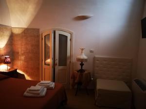 a bedroom with a bed and a table with a lamp at B&B Corti Carmela in Gallipoli