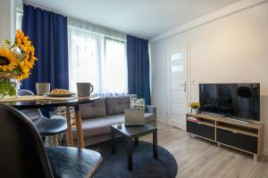 a living room with a couch and a table at W&K Apartments - Compact I in Koszalin