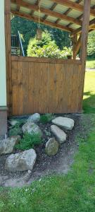 a garden with rocks in front of a wooden fence at Pension U Štěpánků in Trpišovice