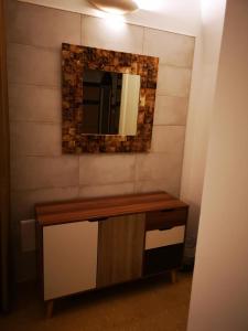 a bathroom with a vanity with a mirror on the wall at B&B Corti Carmela in Gallipoli