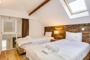 a bedroom with two beds and a window at Hopstays Oporto Tiles 2 - City Center Duplex in Porto