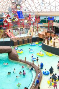 a group of people in an indoor water park at Big Home Game Room, Hot Tub and 17-Seat Theater in Massanutten